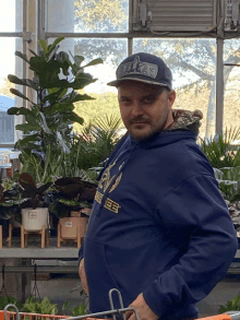 a man wearing a texas hat and a blue hoodie