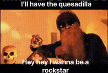 a man with a beard and sunglasses is pointing at a skull and says " i 'll have the quesadilla "