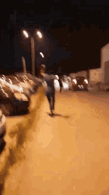 a blurry picture of a person riding a skateboard down a street at night