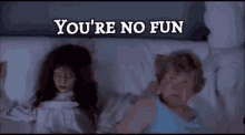 a woman is laying in bed with a ghost and the words " you 're no fun "