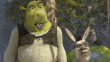 shrek and donkey are standing next to each other in a forest .