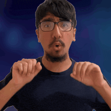 a man wearing glasses and a beard is making a surprised face