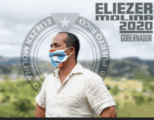 a man wearing a face mask stands in front of a poster for eliezer molina 2020 governador