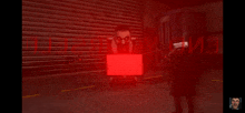 a man in a wheelchair with a red light behind him that says ' evil ' on it