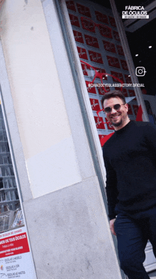 a man standing in front of a ray-ban store