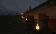 a minecraft bridge with lanterns hanging from it at night