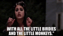 a woman is singing a song with all the little birdies and the little monkeys .