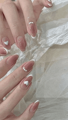 a close up of a woman 's nails with a white french manicure