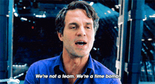 a man in a blue shirt is saying we 're not a team . we 're a time bomb .