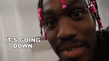 a close up of a man 's face with the words it 's going down behind him