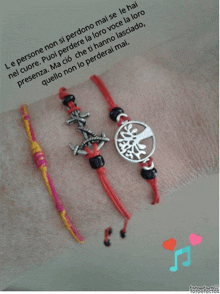 a person 's wrist with three bracelets on it and a quote in the background