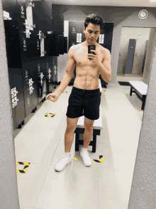 a man taking a picture of himself in a locker room