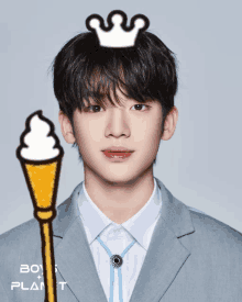 a boy with a crown on his head next to a ice cream cone