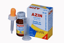 a box of azin powder for suspension sits next to a bottle of azin