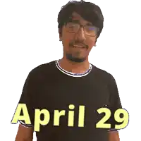 a man wearing glasses and a black shirt with the date april 29
