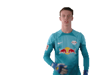 a soccer player wearing a blue shirt with red bulls on it