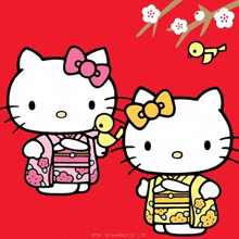 hello kitty is wearing a pink kimono and holding a bird .