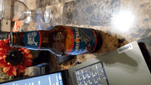 a bottle of abita christmas beer sits on a counter next to a lenovo laptop