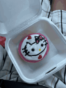 a hello kitty doughnut in a styrofoam container