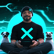 a man wearing a black shirt with an x on it sits with two pugs