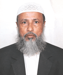 a man with a beard is wearing a black suit and a white hat