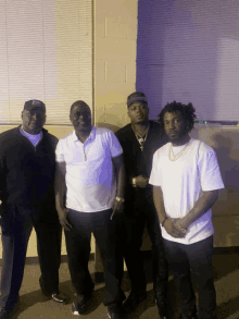 a group of men pose for a picture with one wearing a hat that says chicago bulls