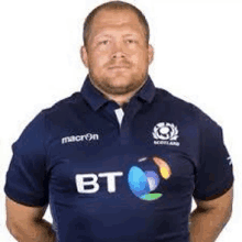 a man with a beard is wearing a blue rugby shirt .