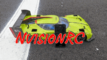 a yellow rc car with the words nivisionrc in red letters