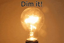 a light bulb is lit up with the words dim it above it