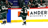 a hockey player wearing a jersey with the number 43 on it is skating on the ice .