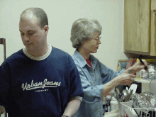 a man wearing a urban jeans company shirt stands next to a woman