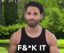 a man with a beard is wearing a black tank top and has the words f & * k it on his chest .