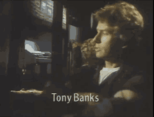 a man in a dark room with the name tony banks on the screen