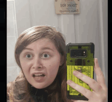 a woman taking a selfie in front of a sign that says " i love you " on it