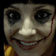 a close up of a woman 's face with blood coming out of her eyes