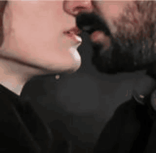 a man and a woman are kissing each other on the cheek .