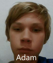 a close up of a person 's face with the name adam written on it