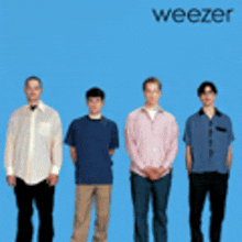 four men standing in front of a blue background with the word weezer