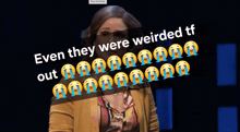 a woman stands in front of a sign that says " even they were weirded tf "