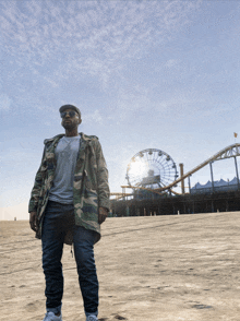 a man standing in front of a ferris wheel