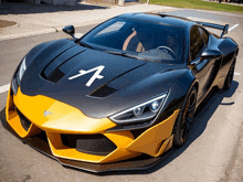 a black and yellow sports car with the letter a on it