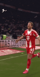 a soccer player in a red and white jersey with the number 9 on it
