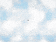 a small cartoon character is flying through the air on a gray background .
