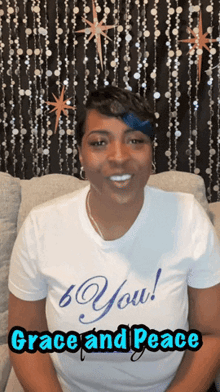 a woman wearing a t-shirt that says " you " and " grace and peace "
