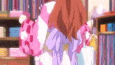 a girl in a pink and purple kimono is holding a bag