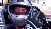 a man wearing a stilo helmet and gloves looks at the camera