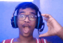 a man wearing headphones and glasses is making a funny face