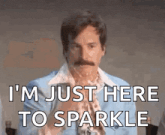 a man with a mustache and a blue jacket says i 'm just here to sparkle
