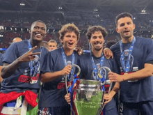 a group of soccer players holding a trophy that says champions