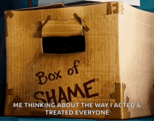 a cardboard box has the words box of shame on it